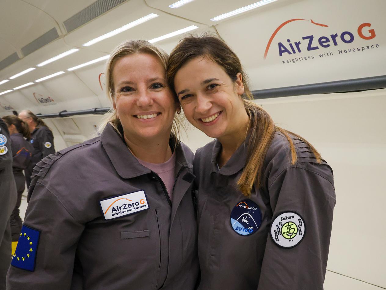 Melanie und Daniela in Overalls mit Aufnähern, darunter „Air Zero G“ und „Saturn“.