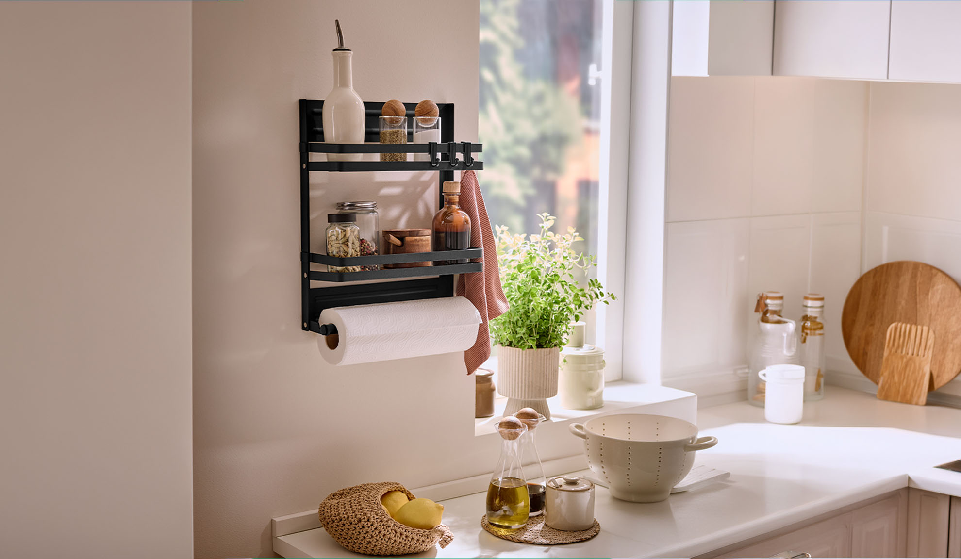 Schwarzes Küchenregal mit Gewürzen, Küchenrolle und einer Pflanze am Fenster.